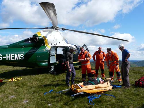 Casualty is carried uphill to helicopter