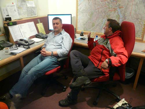 The team's dog handler and team leader discuss the plan. Team leader pretends he was awake all along.