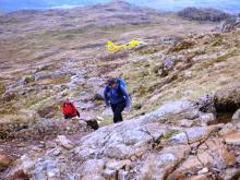 People, crags, helicopter