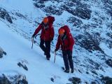 Team members leave the site to make their way down