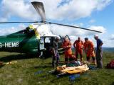 Casualty is carried uphill to helicopter